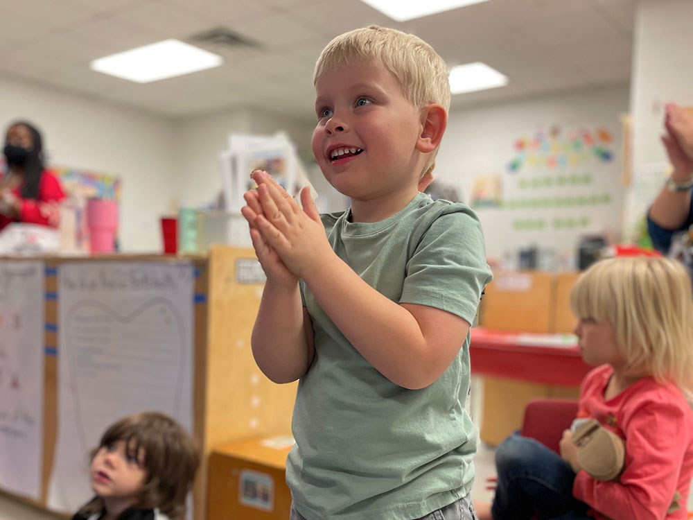 Child engaging in learning in a classroom